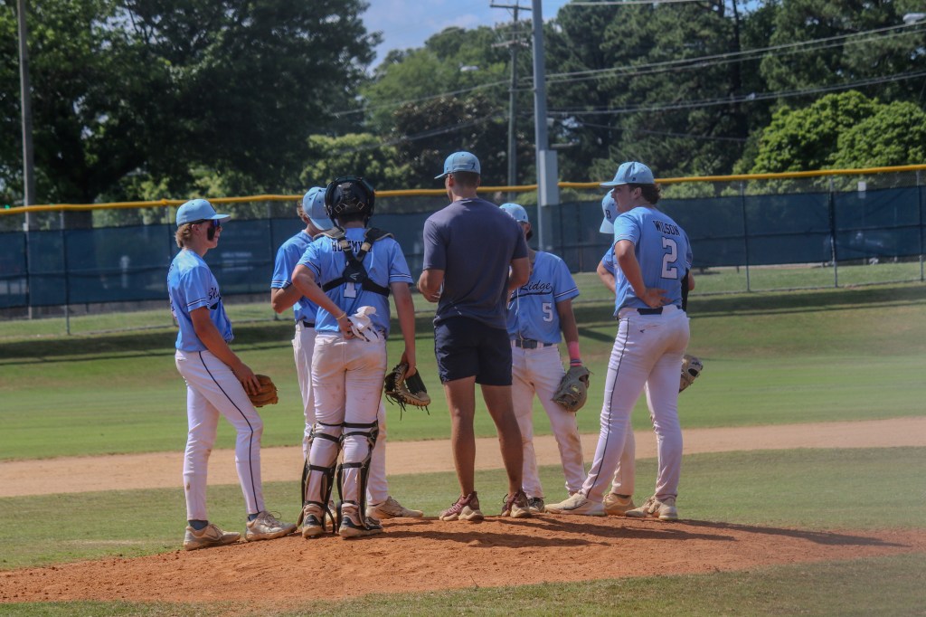 BRE Fall 14U players huddle on the infield