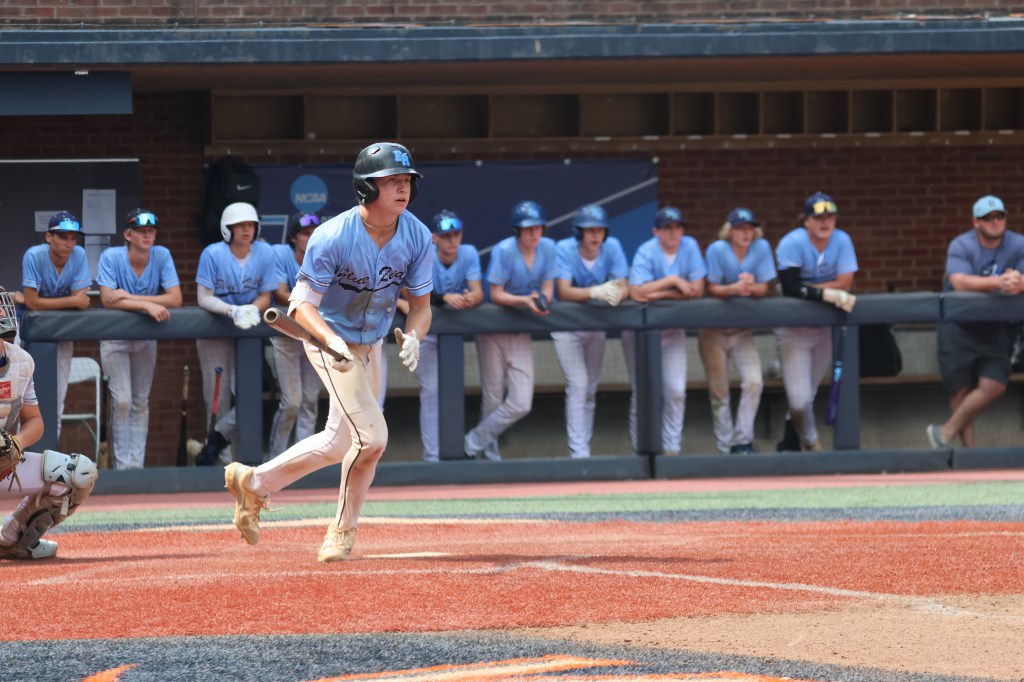 BRE Fall 15U batter heads to first with the dugout behind him